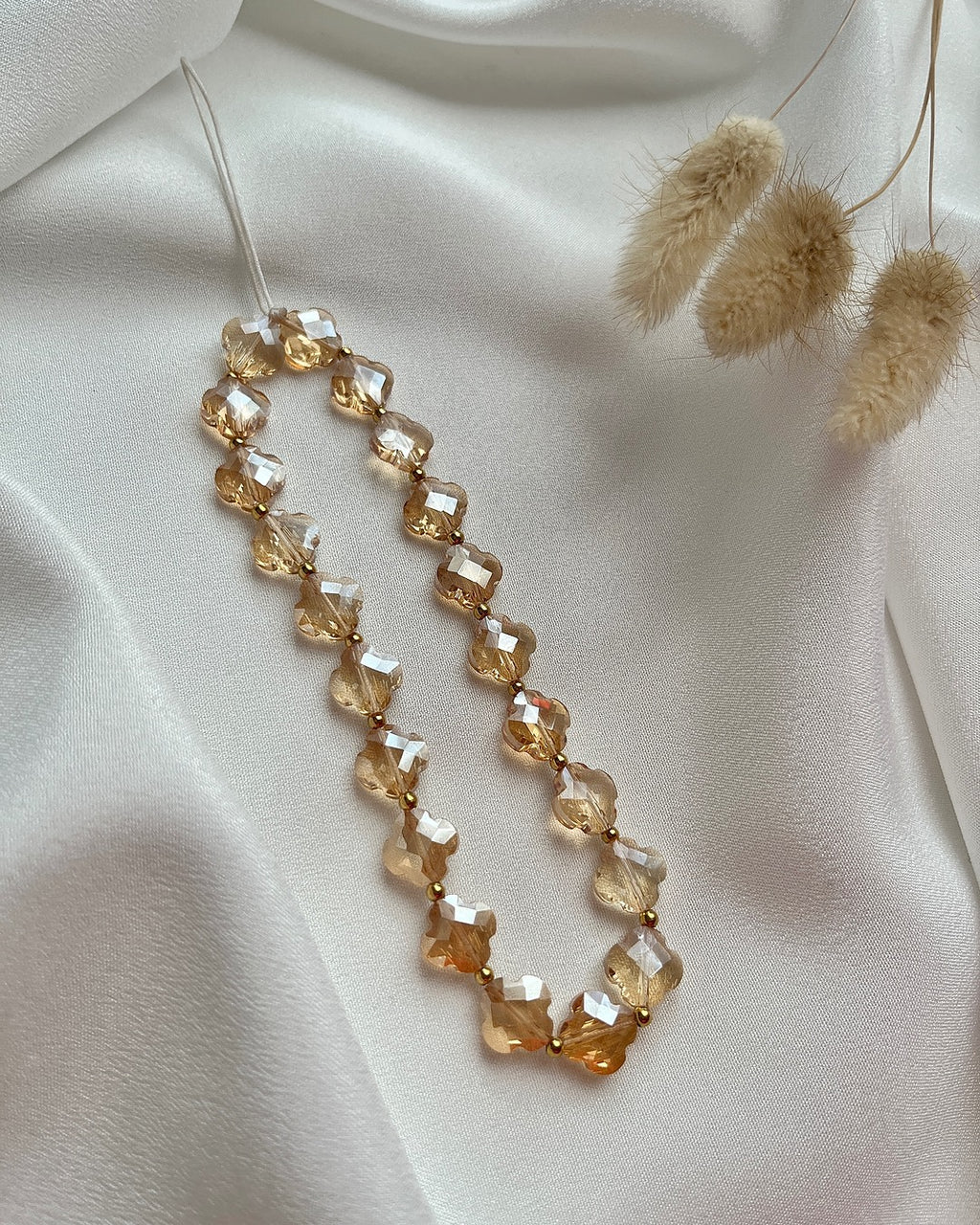 Handykette aus goldenem Clover