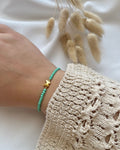 Perlenarmband aus türkisen Perlen & Schmetterlings-Charm