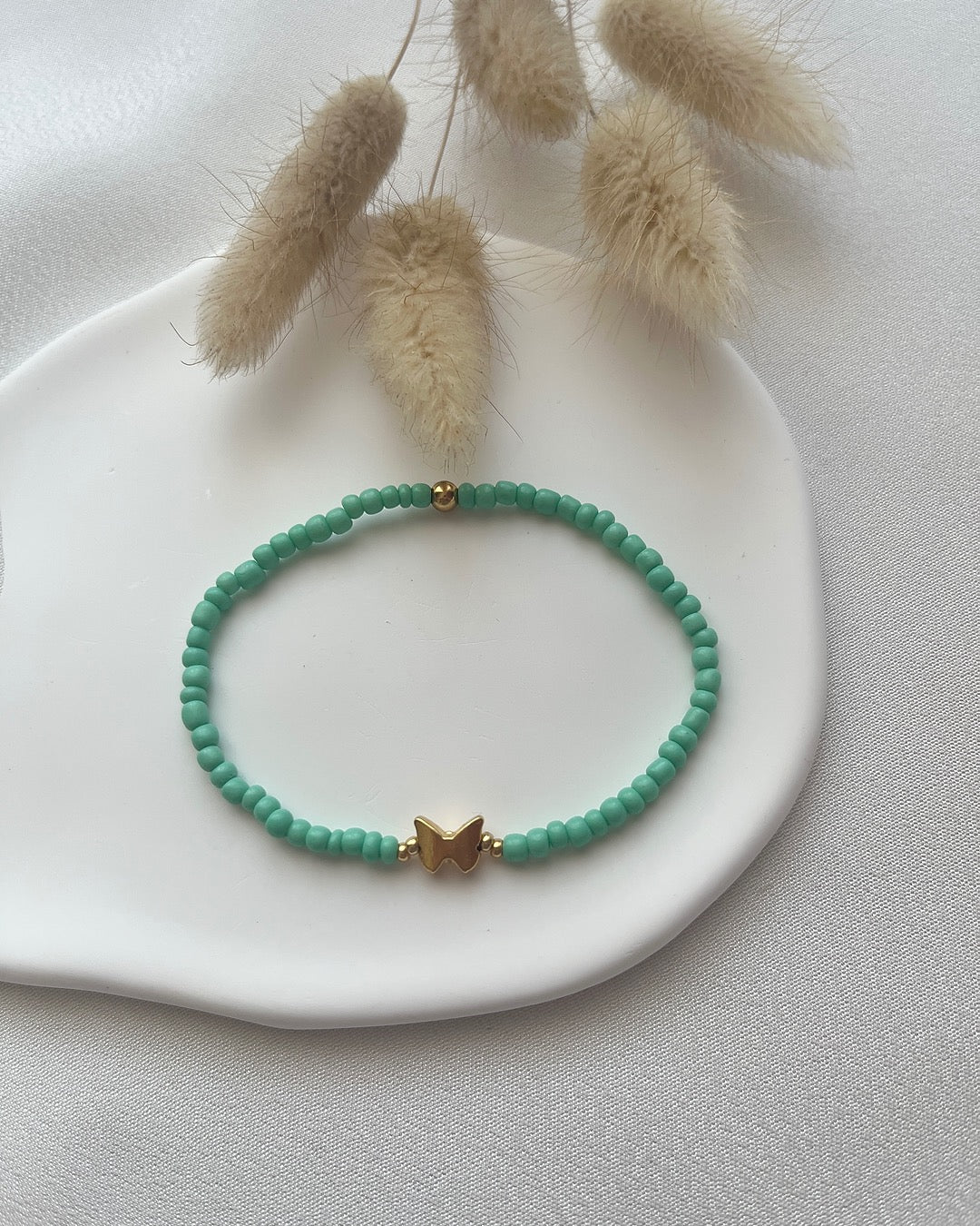 Perlenarmband aus türkisen Perlen & Schmetterlings-Charm