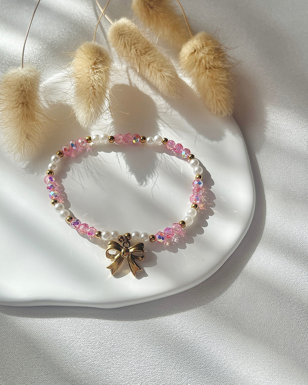 Perlenarmband in Weiß und Rosa & Schleifen-Anhänger
