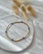 Perlenarmband aus goldenen Miyuki-Perlen & Nazar