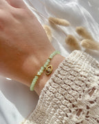 Perlenarmband in Hellgrün & Auge-Anhänger