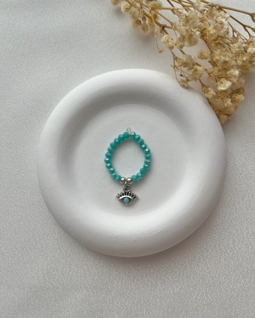 Perlenring in Türkis & Auge-Charm in Silber